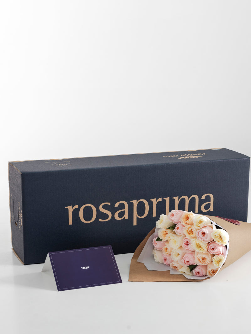 Bouquet of garden roses with a 'rosaprima' box on a white background