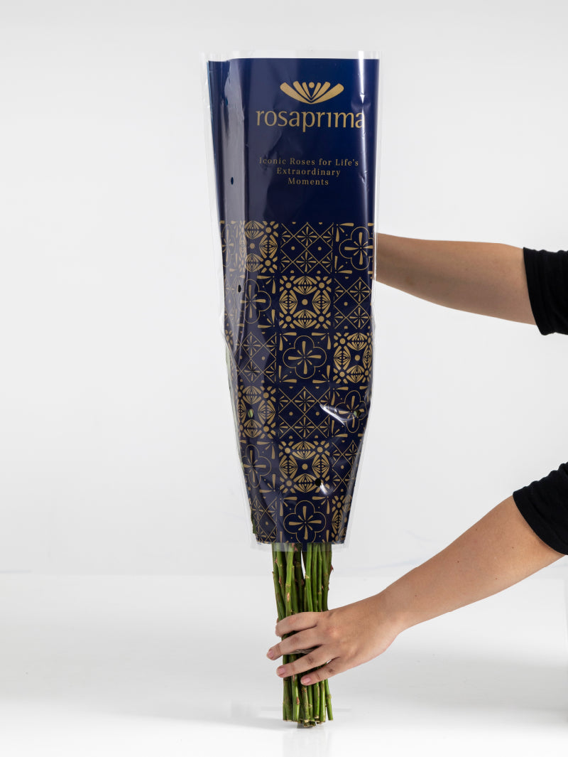 Bouquet of flowers wrapped in Rosaprima packaging on a white background.